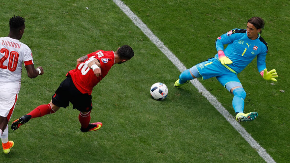 Switzerland goalkeeper Yann Sommer saves on Albania's Armando Sadiku. (AP)