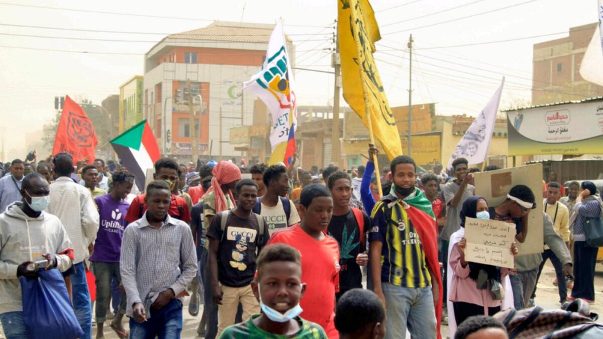 Demonstrators march during ongoing protests calling for civilian rule and denouncing the military administration, in the Sahafa neighbourhood in the south of Sudan's capital Khartoum. — AFP