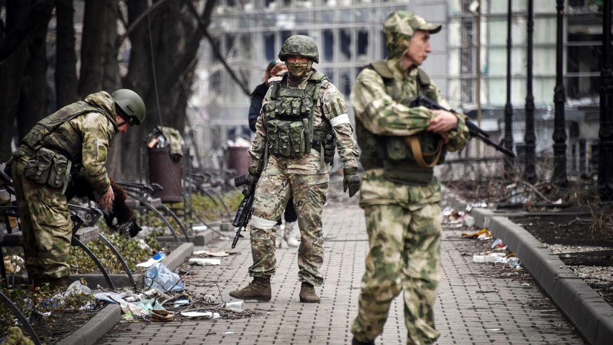 Russian soldiers walks along a street in Mariupol on April 12, 2022. Photo: AFP