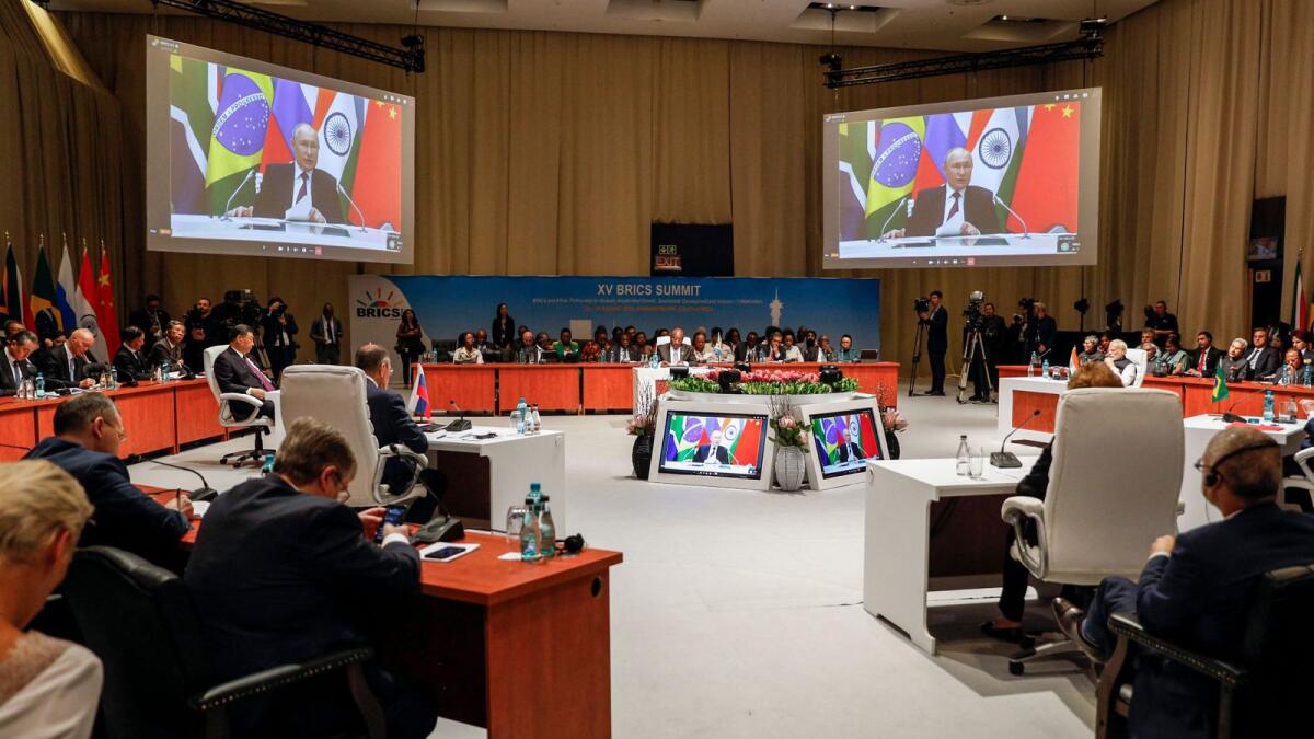 Delegates attend the plenary session as Russian President Vladimir Putin delivers his remarks virtually during the 2023 Brics Summit at the Sandton Convention Centre in Johannesburg on Wednesday. — AFP