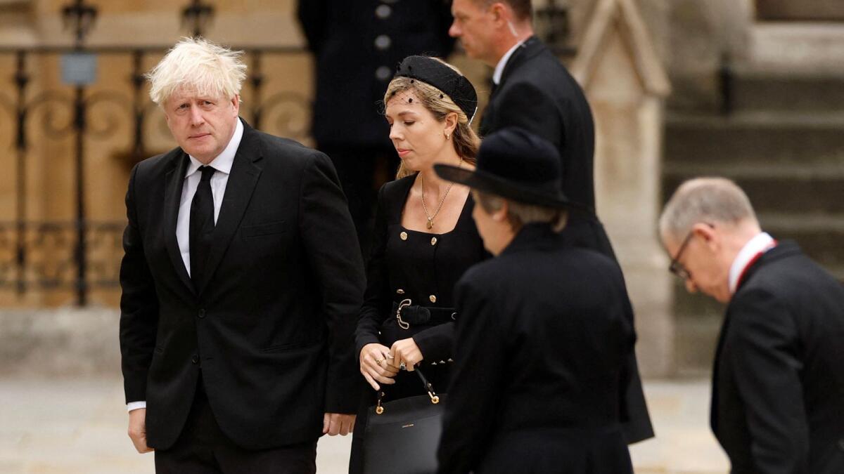 Former British Prime Minister Boris Johnson and his wife Carrie Johnson arrive at Westminster Abbey.