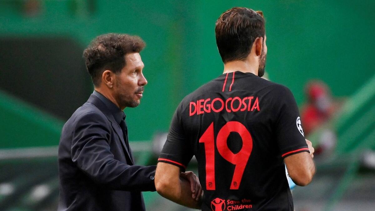Atletico Madrid coach Diego Simeone talks to Diego Costa