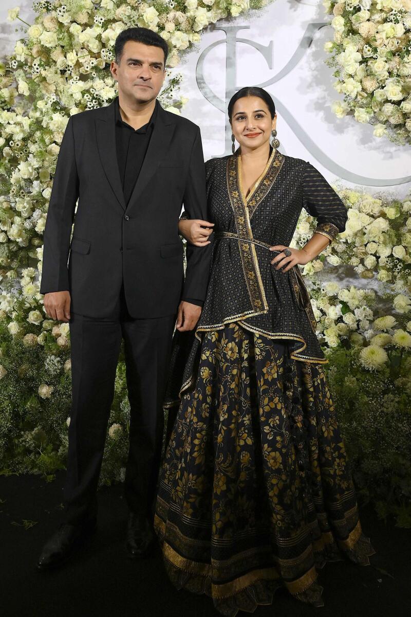 Siddharth Roy Kapur with  actress wife Vidya Balan who picked an unusual black print lehenga with a high and low top