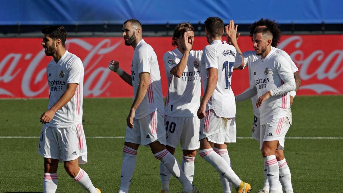 Karim Benzema and teammates celebrate a goal against Huesca. — AP