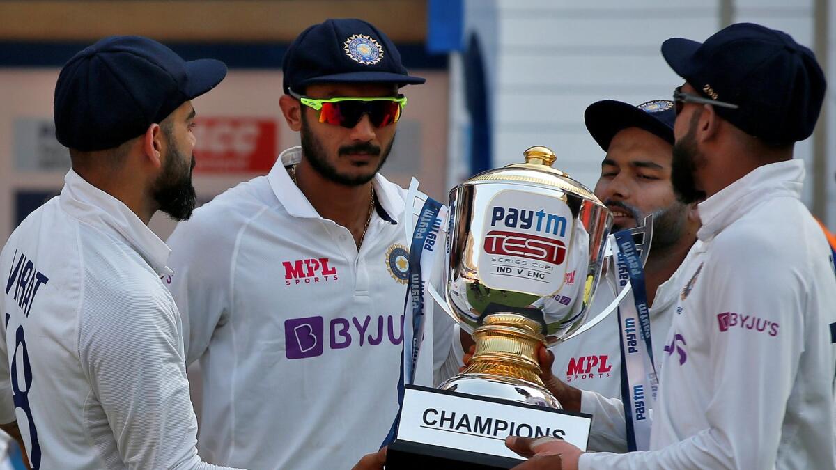 India's captain Virat Kohli, Axar Patel, Rishabh Pant and Mohammed Siraj hold the trophy. — Reuters