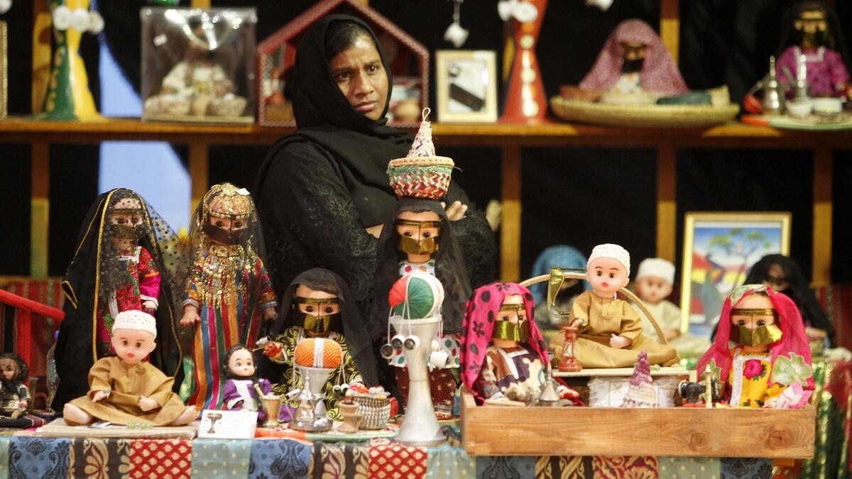 DECKED UP WITH DOLLS... Handmade dolls dressed in traditional Arab costumes are on sale at the festival. (M. Sajjad)