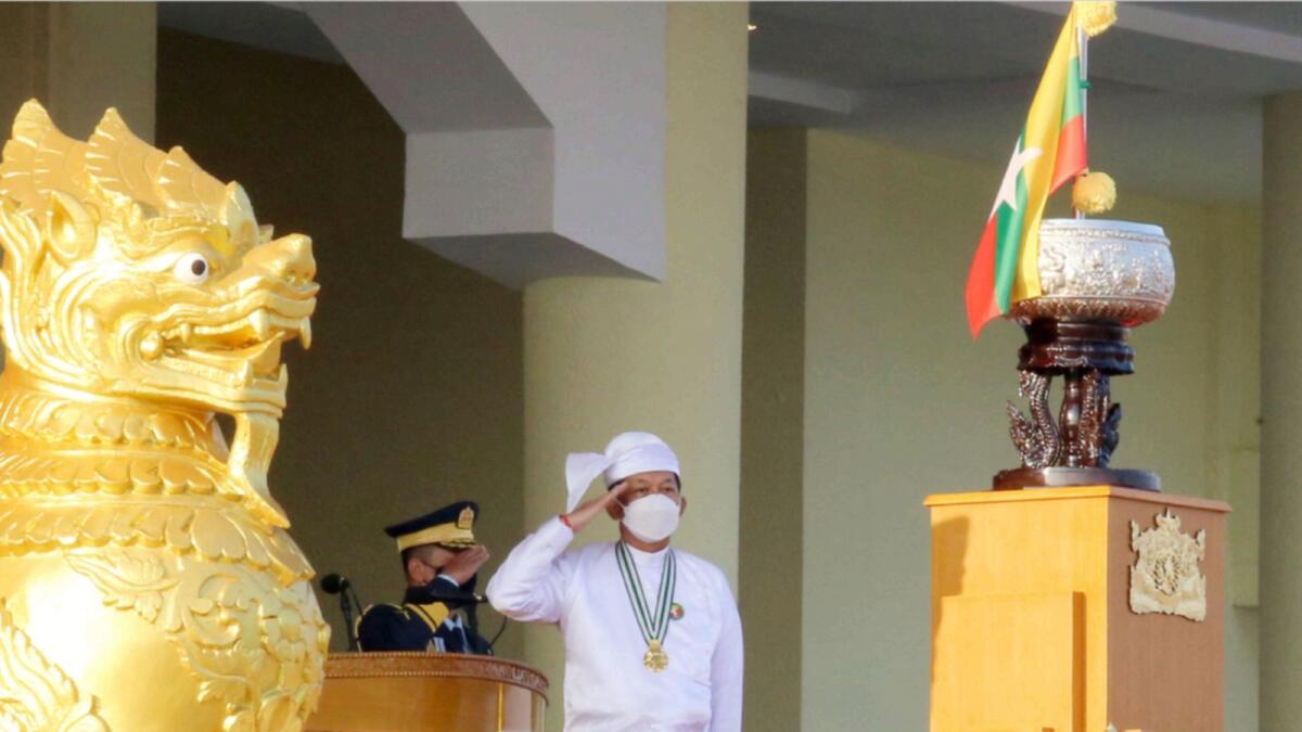 Myanmar's junta chief senior general Minn Aung Hlaing (C) salutes during a ceremony to mark the 75th anniversary of the country's Union Day. — AFP