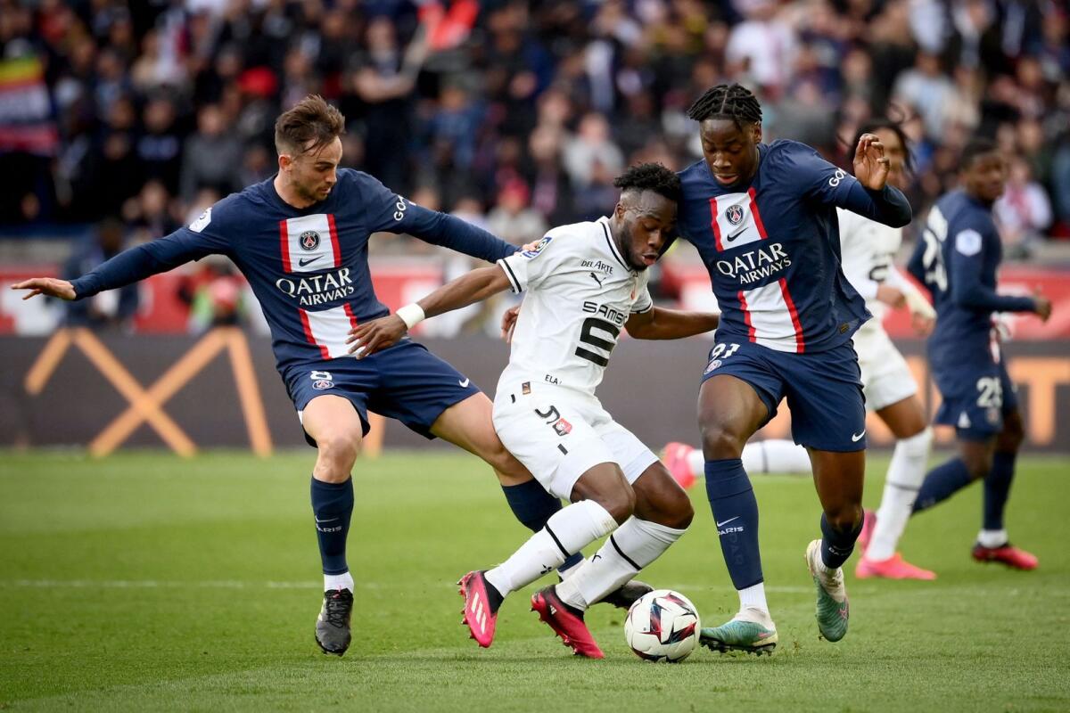 Rennes' Arnaud Kalimuendo fights for the ball with Paris Saint-Germain's Fabian Ruiz and El Chadaille Bitshiab. — AFP