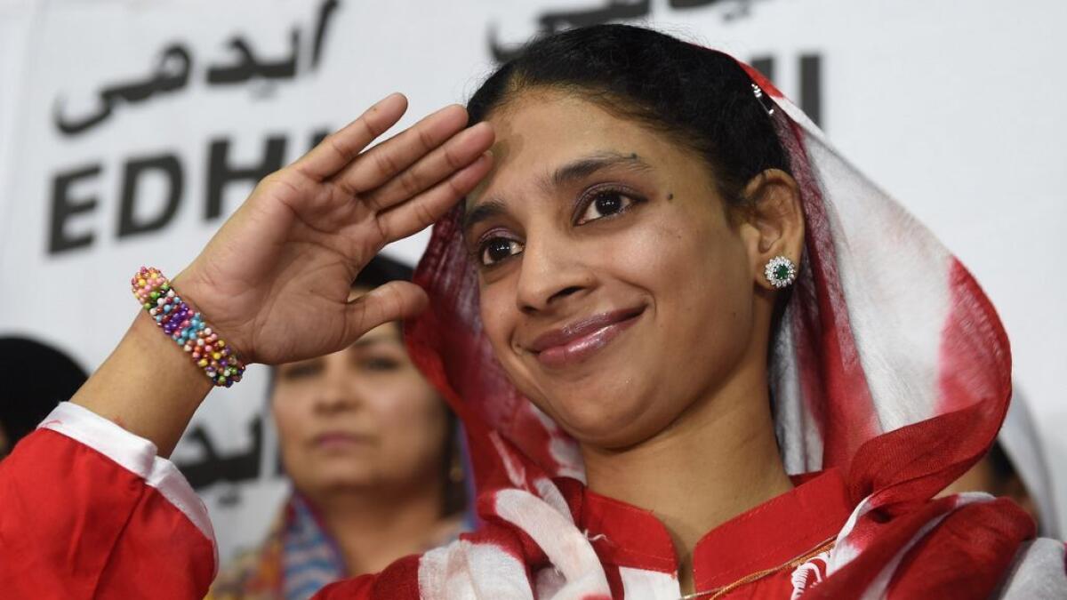 Geeta to salutes the media before leaving for the airport from the EDHI Foundation in Karachi.