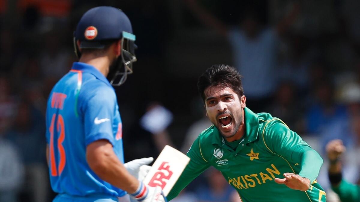Pakistan bowler Mohammad Amir celebrates after taking the wicket of Indian captain Virat Kohli (AFP)