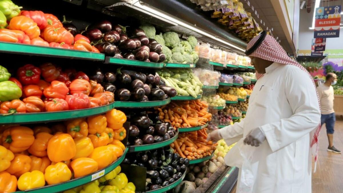 A Saudi man buys vegetables at a supermarket in Riyadh. — Reuters