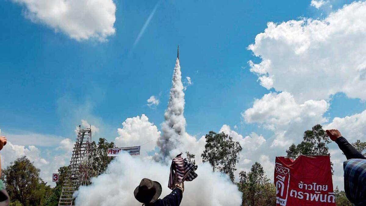 Participants rejoice after launching a home-made rocket during the ‘Bun Bang Fai’ festival in Yasothon, Thailand. — AFP