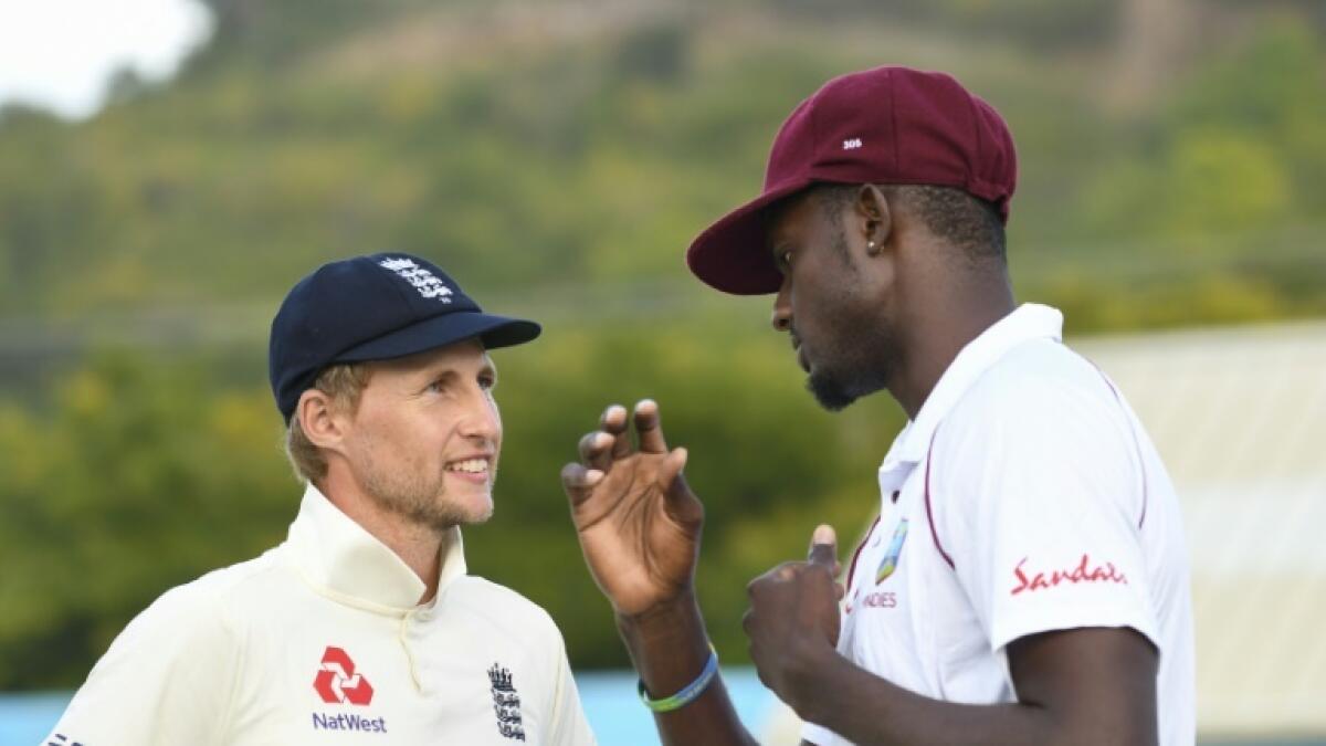 England Test captain Joe Root (left) and West Indies skipper Jason Holder. - AFP file
