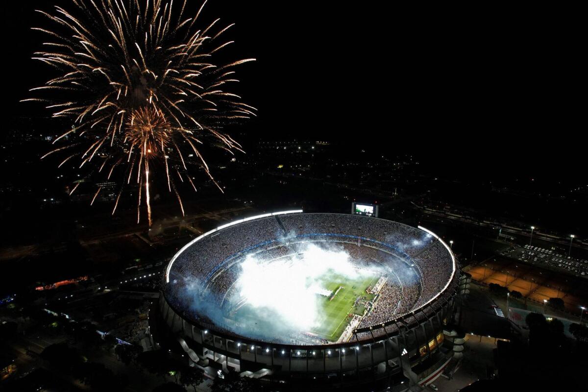 Aerial view of fireworks exploding before the start of the friendly match at the Monumental stadium in Buenos Aires. — AFP