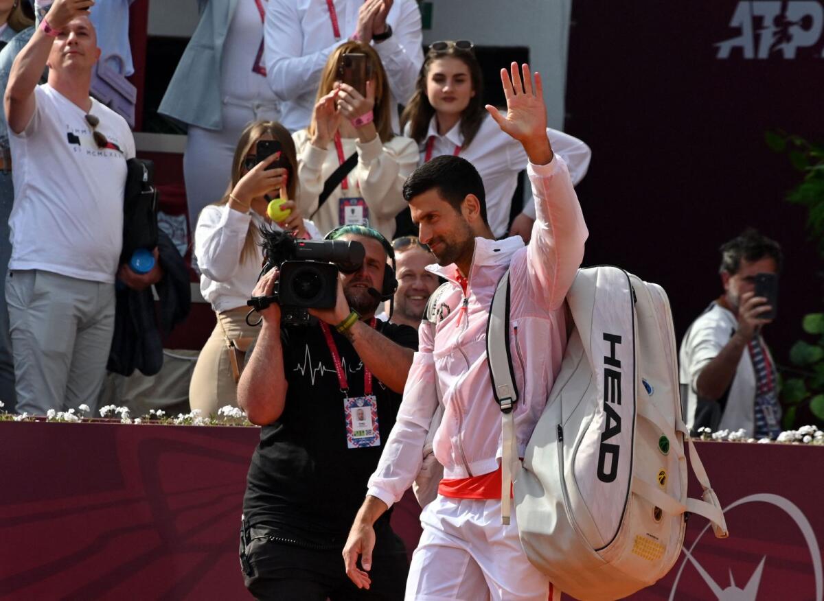 Serbia's Novak Djokovic (centre) waves to the crowd following his match. — AFP