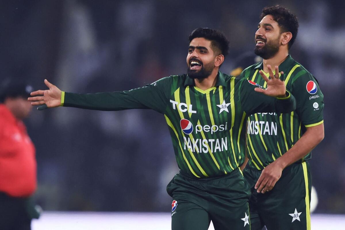 Pakistan's captain Babar Azam (left) and teammate Haris Rauf celebrate after the dismissal of New Zealand's Mark Chapman (not pictured) during the first T20 match at the Gaddafi Cricket Stadium in Lahore on Friday. — AFP