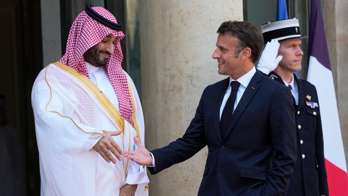 Saudi Crown Prince Mohammed bin Salman prepares to shake hands with French President Emmanuel Macron on June 16, 2023 at the Elysee Palace in Paris. — AP file