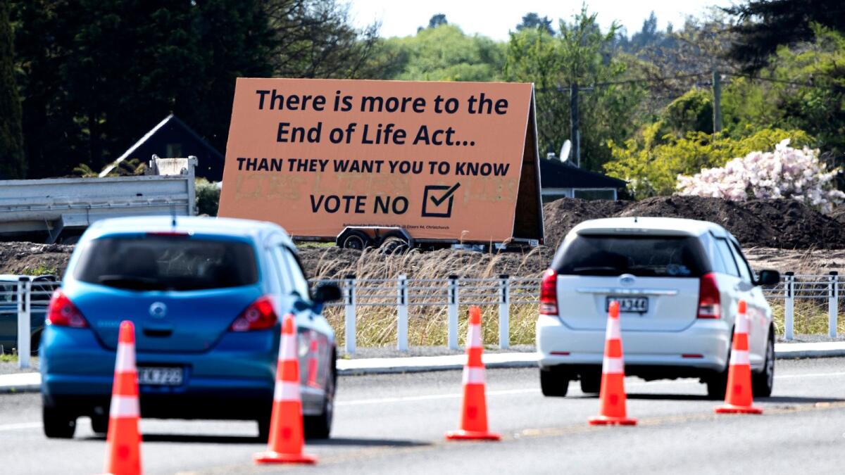 Cars are driven past a billboard urging voters to vote 'No' against euthanasia in Christchurch, New Zealand.