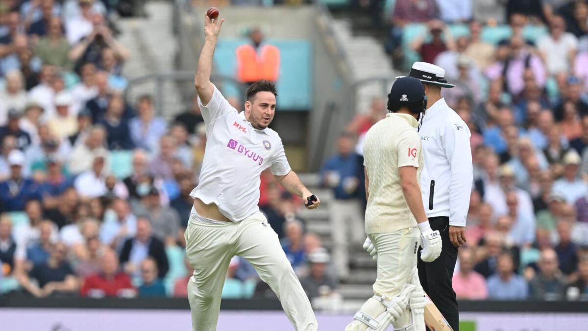 Pitch invader Daniel Jarvis pretends to bowl as he delays play on the second day of the fourth Test between England and India at the Oval Cricket Ground. (AFP)