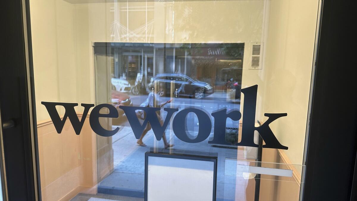 A sign for WeWork is displayed at their office in the borough of Manhattan in New York. —  AP file)
