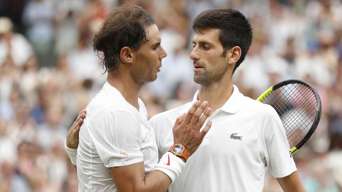 Novak Djokovic (right) and Rafael Nadal, the two ageing champions, continue to overcome the challenges of rising stars in five-set epics. (AFP)