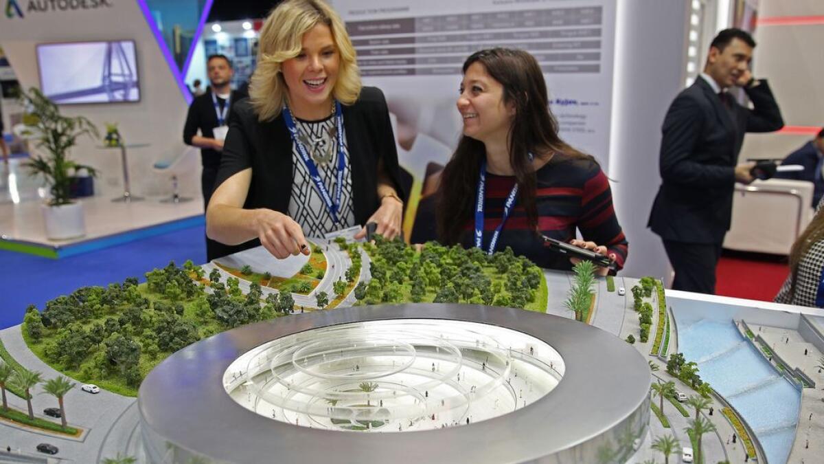 Visitors look at a model at the Hyperloop One pavilion at the Middle East Rail Exhibition on Tuesday.