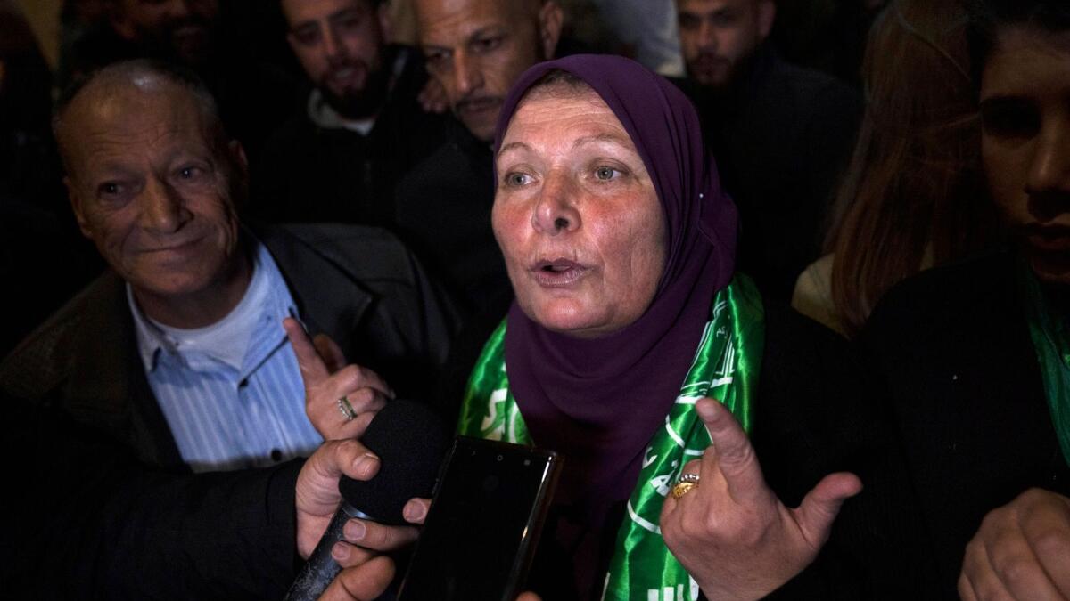 Former Palestinian female prisoner Hanna Barghouti, who was released by the Israeli authorities, talks to the media upon her arrival in the West Bank town of Beitunia, Friday, Nov. 24, 2023. AP