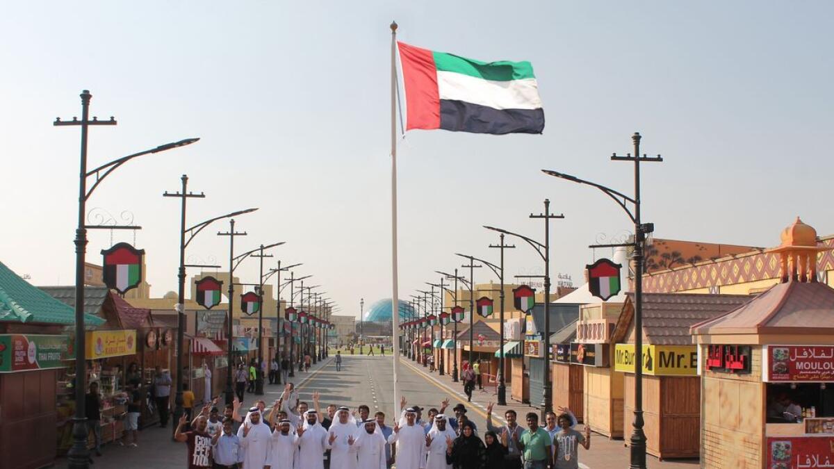 Global Village raises UAE flag in honour of National Flag Day