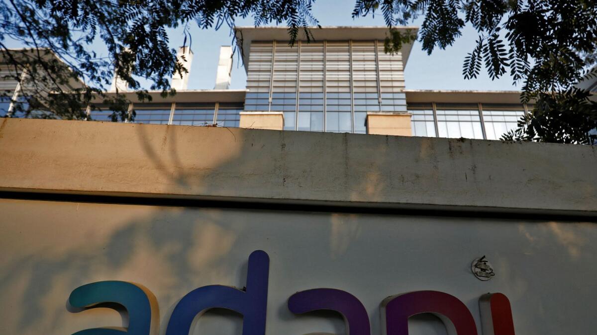 The logo of the Adani Group is seen on the wall of its realty office building on the outskirts of Ahmedabad, India. — Reuters