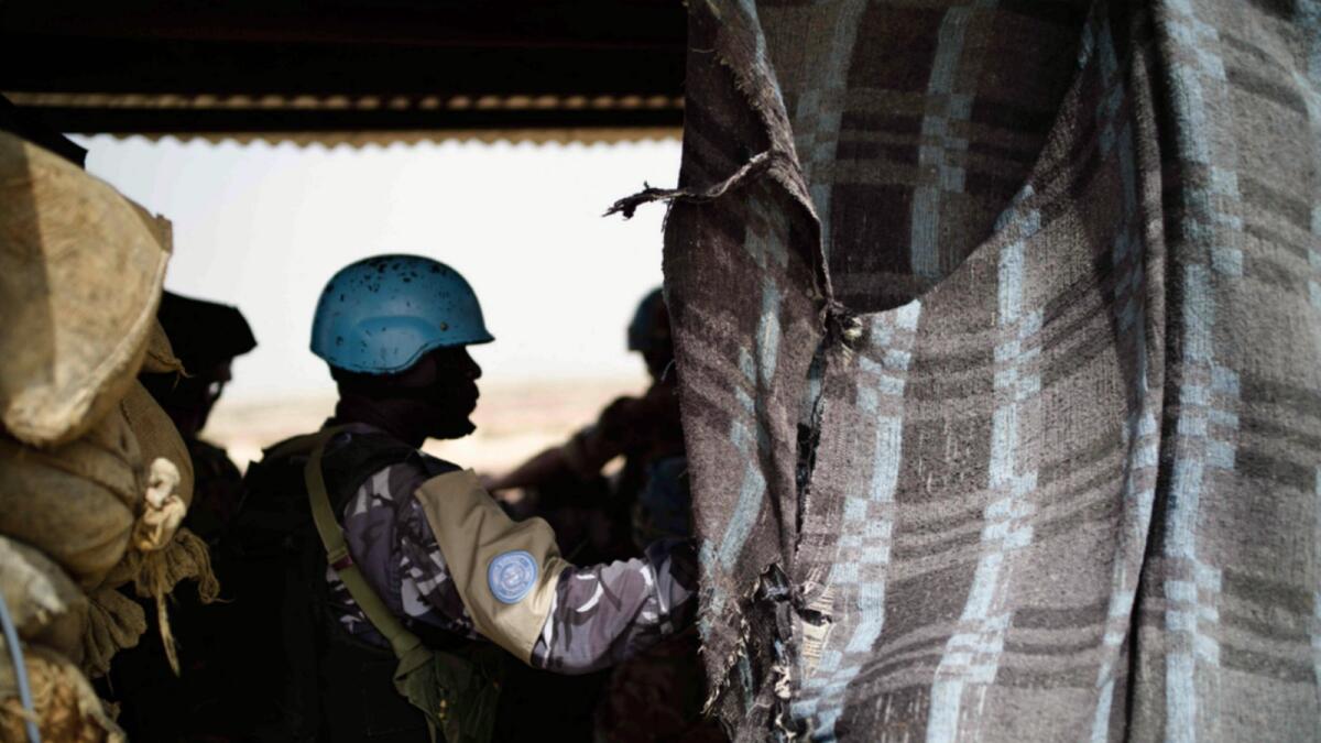 UN peacekeepers look out over the desert from a watchtower in Menaka, Mali. — AP file