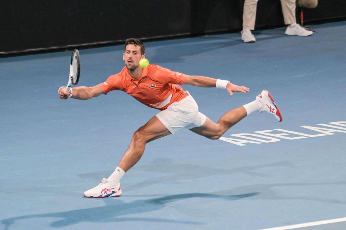 Novak Djokovic hits a return during his semifinal match against Daniil Medvedev. — AFP