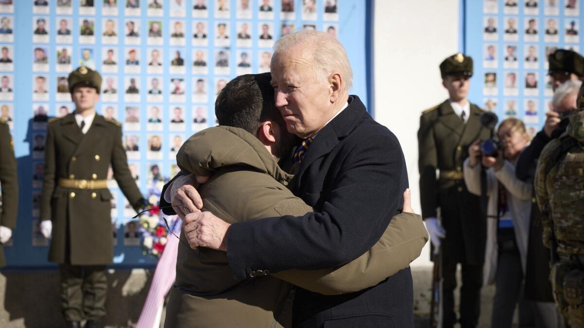 Joe Biden and Volodymyr Zelensky hug as they say goodbye at the Memorial Wall of Fallen Defenders of Ukraine in Russian-Ukrainian War. — AP