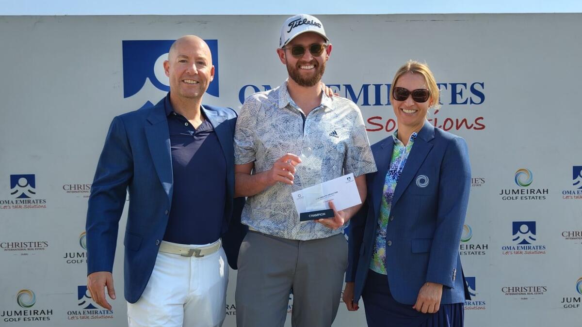 Aron Lomax, the winner of the recent OMA Emirates Medalford at Jumeirah Golf Estates flanked by the Men's and Lady Captains.- Supplied photo