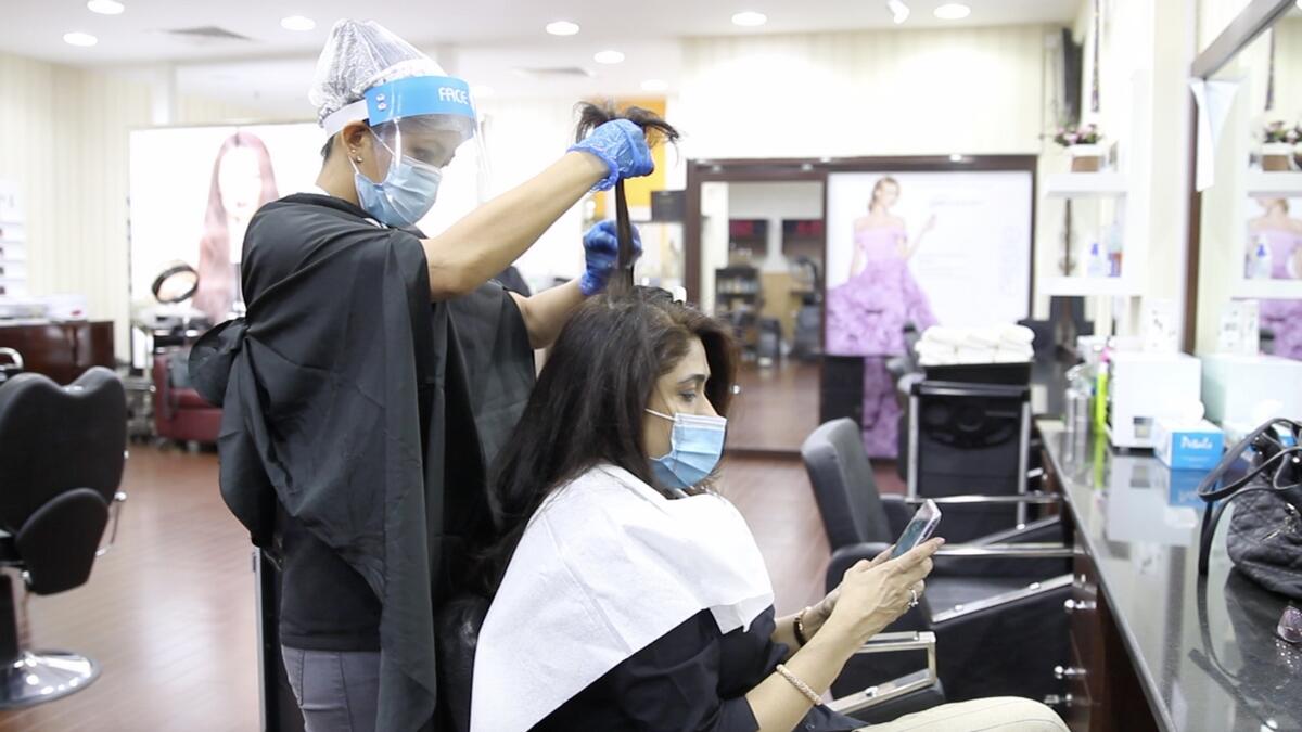 SALONS ARE BACK IN BUSINESS: Opening responsibly parlours in Dubai are welcoming their clients back while nimbly implementing the safety guidelines like mandatory temperature checks of their customers, the moment they step into the facility. Photo by Juidin Bernarrd/KT