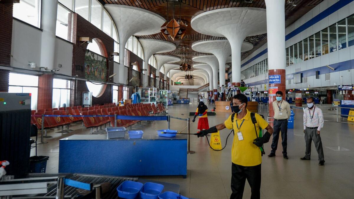 Staff at Hazrat Shahjalal International Airport in Bangladesh spray disinfectants. Photo: AFP