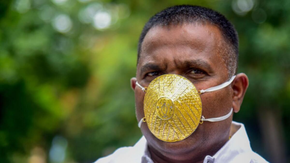 Businessman Shankar Kurhade wears a facemask made of gold and being worth 289,000 rupees amid concerns over the Covid-19 coronavirus outbreak, in Pune on July 4, 2020. Photo by AFP
