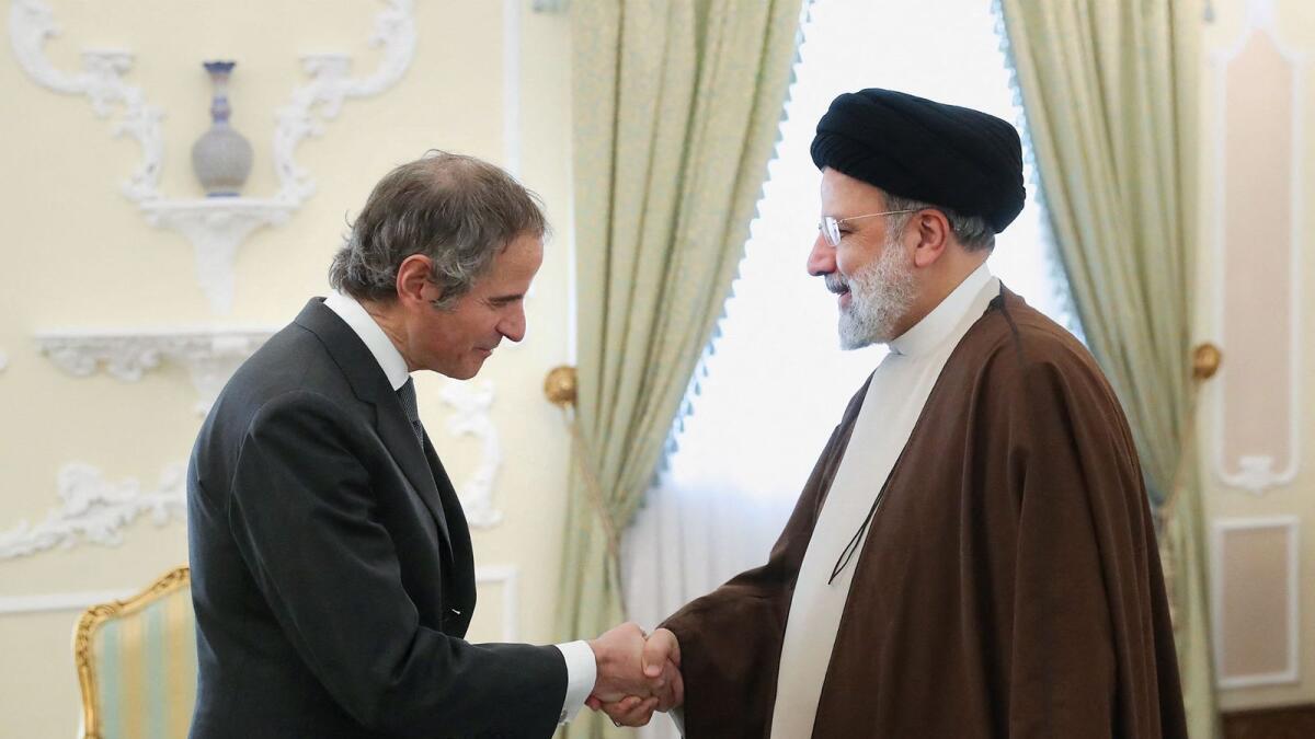 Ebrahim Raisi (R) welcomes Rafael Grossi ahead of their meeting in Tehran. — AFP