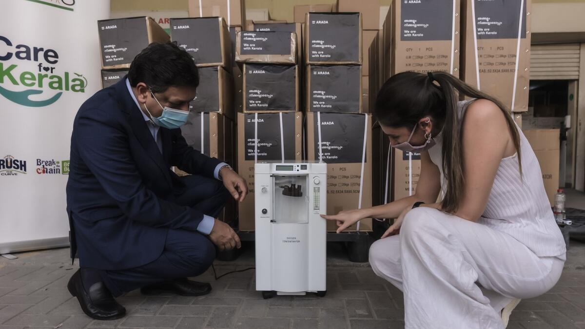 Mohamed Rafi of Norka Roots with Rosa Piro, Business Development Director, Arada, with an oxygen concentrator destined for Kerala.
