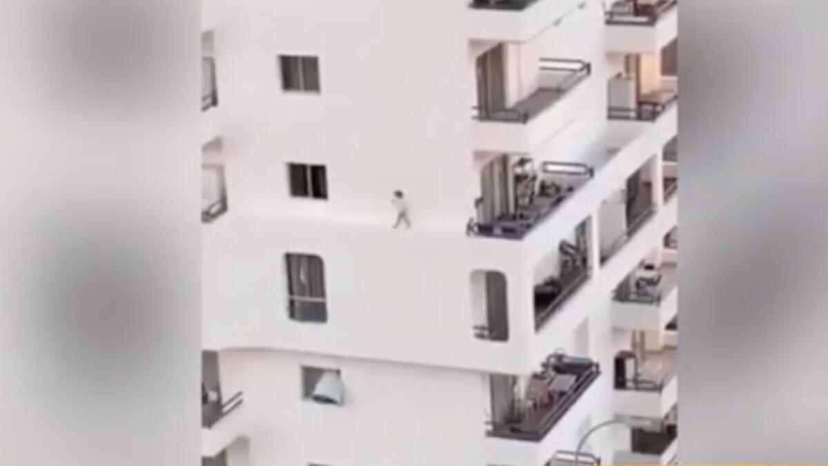 canary island, child walking on ledge of building, viral video, scary video