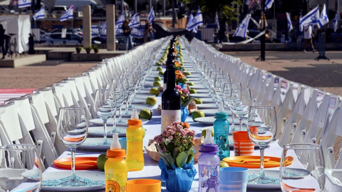 A dinner table is set with empty chairs that symbolically represent hostages and missing people with families that are waiting for them to come home, following a deadly infiltration by Hamas gunmen from the Gaza Strip, in Tel Aviv, Israel. (Photo: Reuters file)