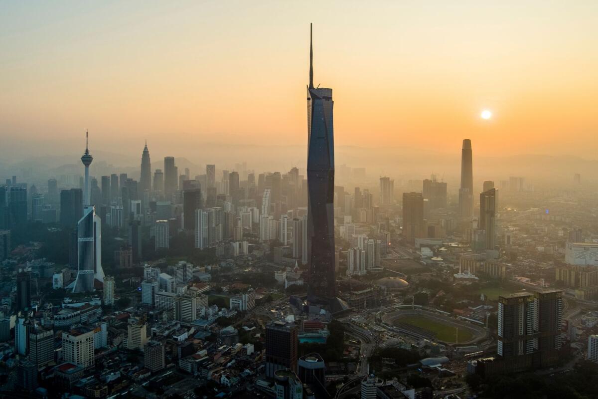 The sun rises over downtown Kuala Lumpur, Malaysia on April 11, 2023. — AP
