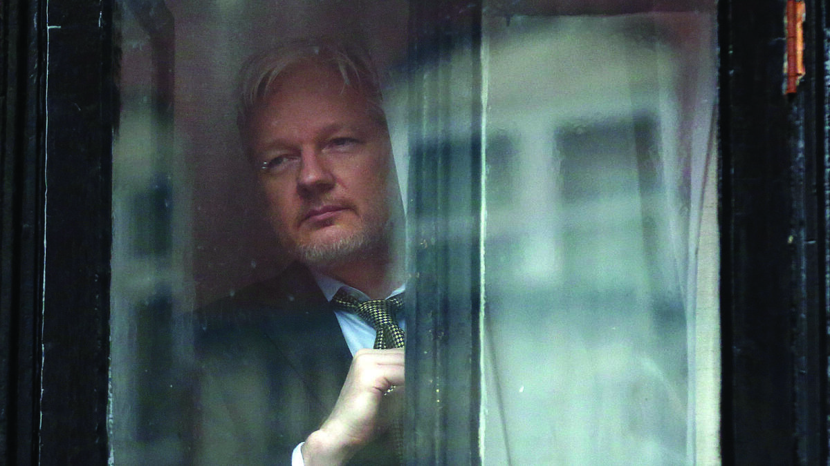 Wikileaks founder Julian Assange prepares to speak from the balcony of the Ecuadorian embassy where  he continues to seek asylum following an extradition request from Sweden.