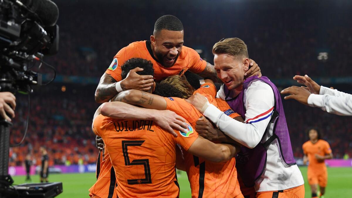 Netherlands players celebrate their second goal against Austria in Amsterdam on Thursday. (AP)