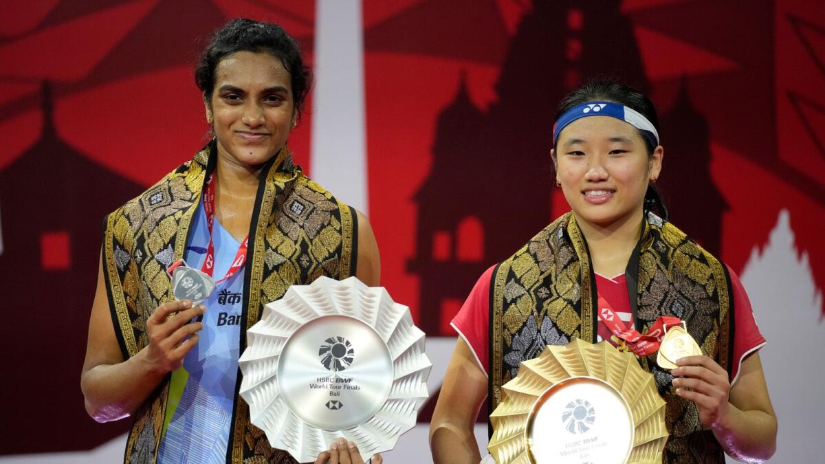 An Se-young of South Korea and PV Sindhu of India pose with their trophies. (AP)