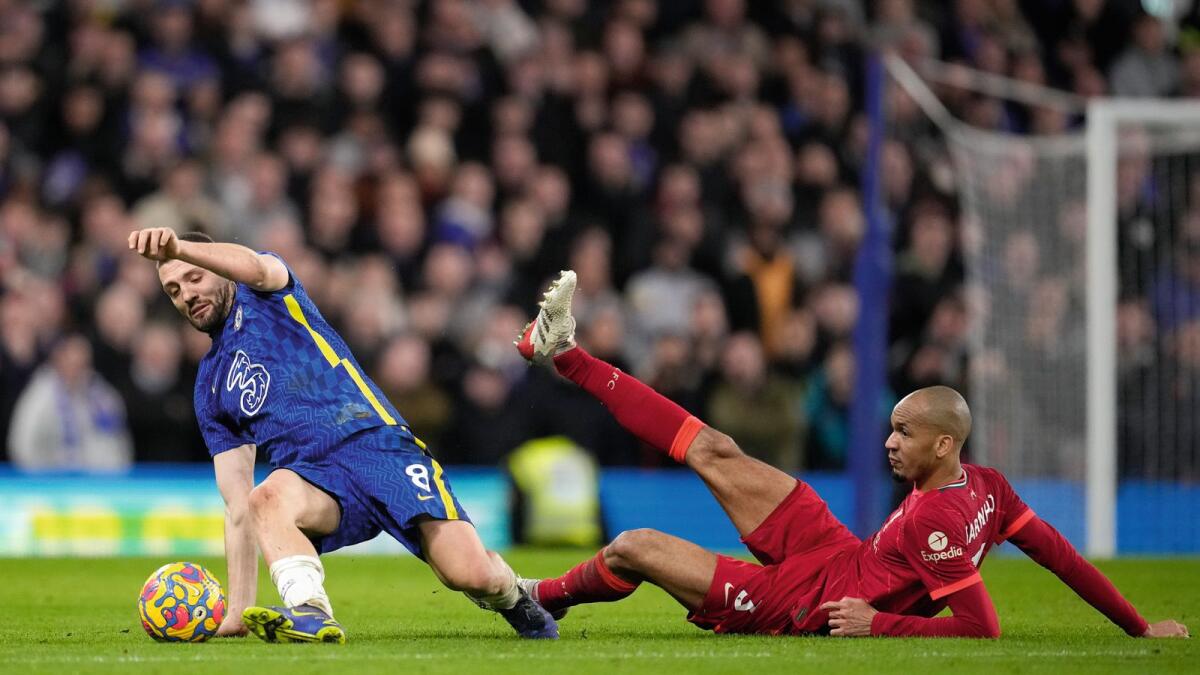 Chelsea's Mateo Kovacic (left) and Liverpool's Fabinho battle for the ball during the English Premier League game at Stamford Bridge in London on Sunday. — AP