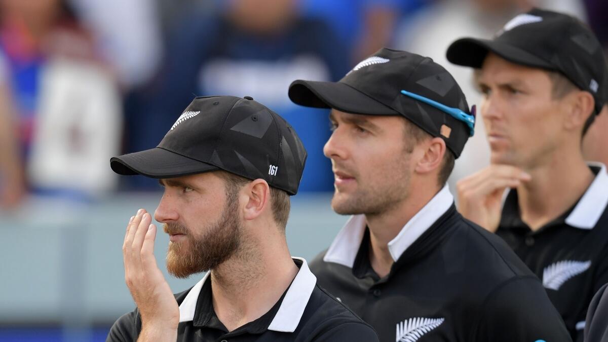 New Zealand's captain Kane Williamson (L) looks on at the trophy presentation after defeat in the 2019 Cricket World Cup final between England and New Zealand at Lord's Cricket Ground in London. AFP