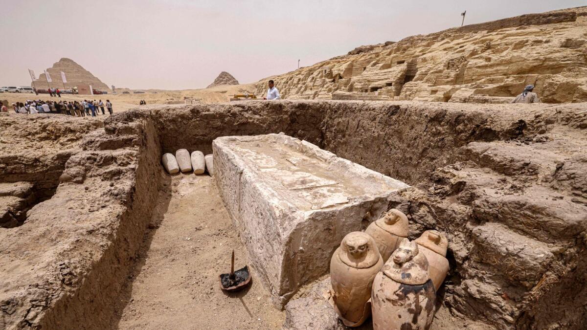 Visitors tour the site in the Saqqara necropolis south of Cairo, where archaeologists unearthed two human and animal embalming workshops, as well as two tombs, on Saturday. — AFP