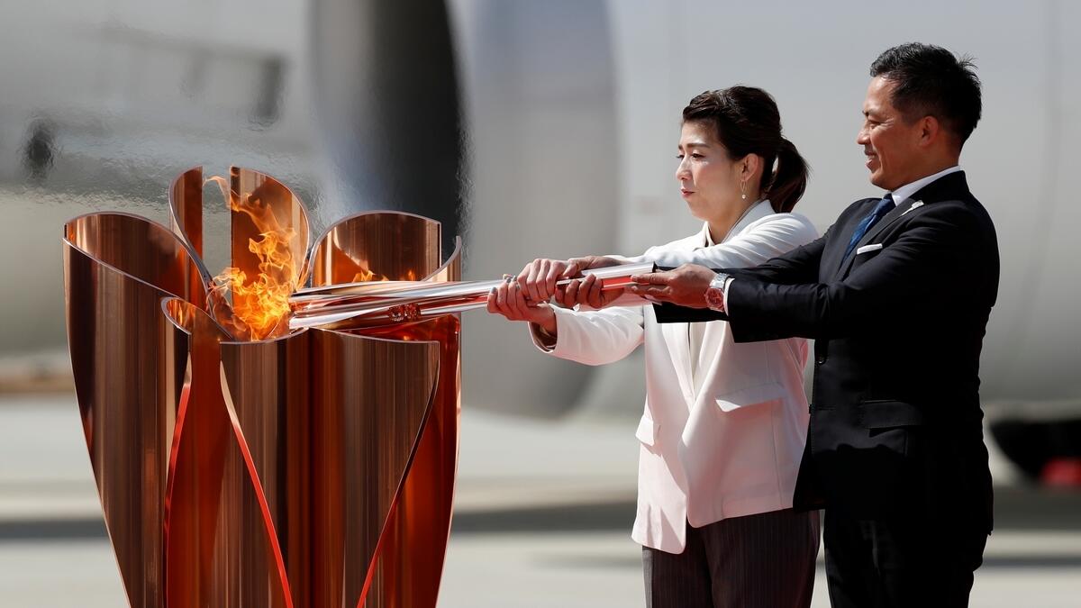 Three-time Olympic gold medalists Tadahiro Nomura and Saori Yoshida light the Olympic Flame at Japan Air Self-Defense Force Matsushima Base in Higashi-Matsuhsima, (Reuters)