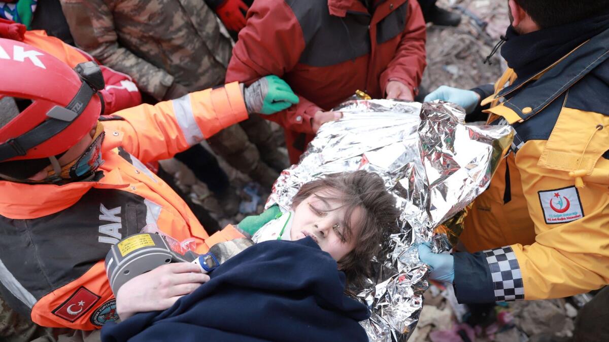Turkish boy Poyraz is carried to an ambulance after being rescued alive from rubbles in the aftermath of a deadly earthquake in Kahramanmaras, Turkey February 10, 2023. REUTERS/Berkcan Zengin NO RESALES. NO ARCHIVES.