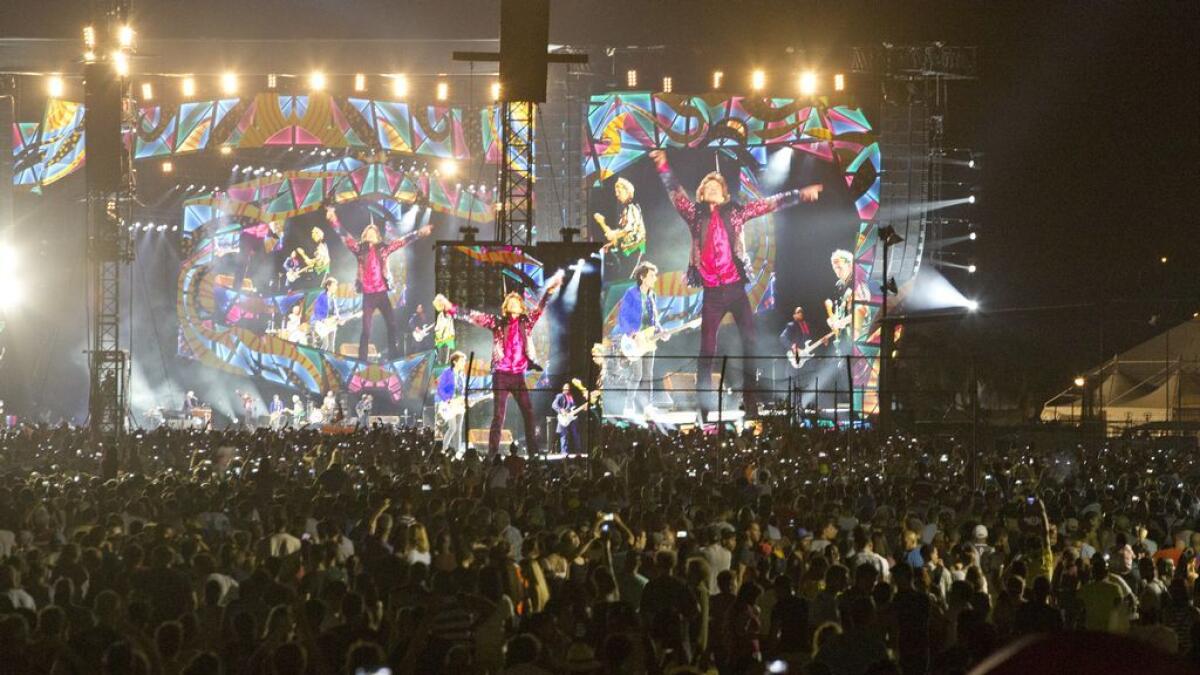 The Rolling Stones are seen on giant screens as they perform for thousands at the Ciudad Deportiva in Havana, Cuba